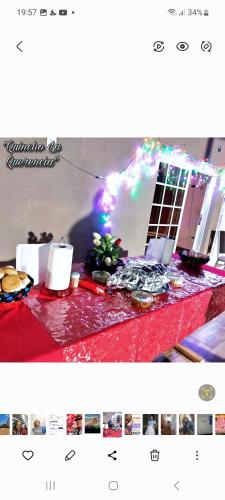 a table topped with a red table cloth with aestival at Quincho la querencia in Posadas