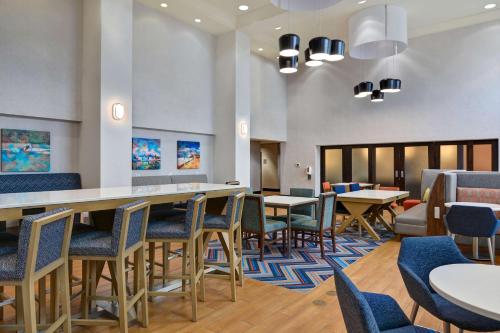 a waiting room with tables and chairs at Hampton Inn & Suites Clearwater St Petersburg Ulmerton Road FL in Clearwater