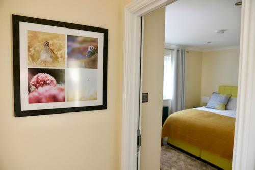 a bedroom with a bed and a picture on the wall at Tu Guesthouse in Stanley