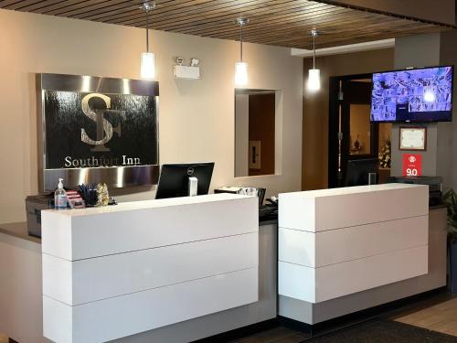 an office with a desk with a sign on the wall at Southfort Inn in Fort Saskatchewan
