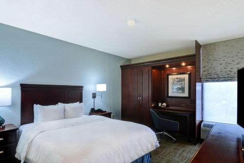 a hotel room with a large bed and a desk at Hampton Inn Charlotte-Gastonia in Gastonia