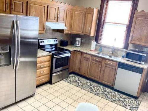 a kitchen with wooden cabinets and stainless steel appliances at Frankfort 2 (V2) in Columbus