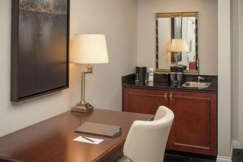 a office with a desk with a laptop and a lamp at Embassy Suites by Hilton Portland Downtown in Portland