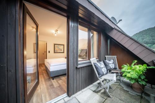 a room with a balcony with a bed and a window at Engel 16 in Gutach