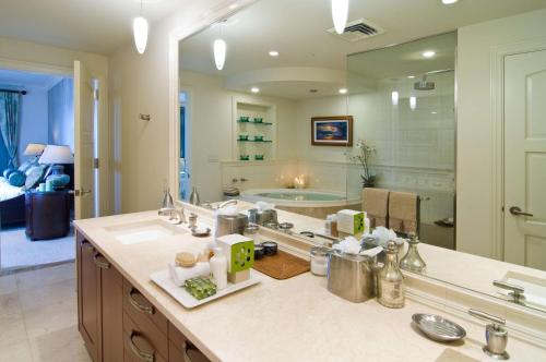a bathroom with a sink and a large mirror at Ho'olei at Grand Wailea in Wailea