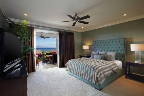 a bedroom with a bed and a flat screen tv at Ho'olei at Grand Wailea in Wailea