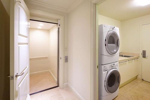 a laundry room with a washer and dryer at Ho'olei at Grand Wailea in Wailea