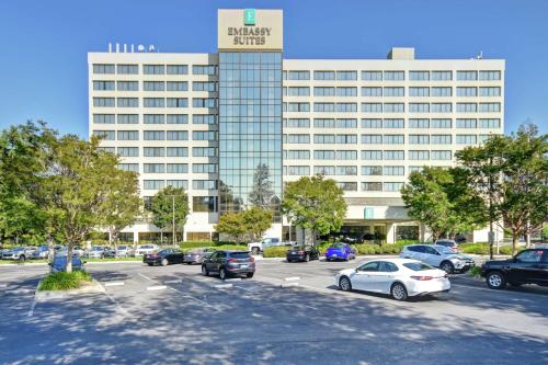 a parking lot in front of a large building at Embassy Suites by Hilton Santa Clara Silicon Valley in Santa Clara
