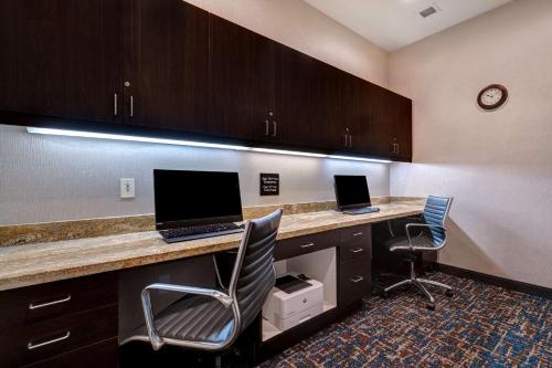 an office with two computers on a desk with two chairs at Hampton Inn & Suites Seattle/Federal Way in Federal Way