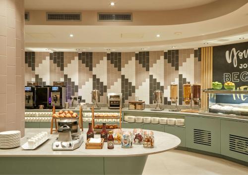 a large kitchen with a table in a restaurant at Hampton By Hilton Dublin City Centre in Dublin