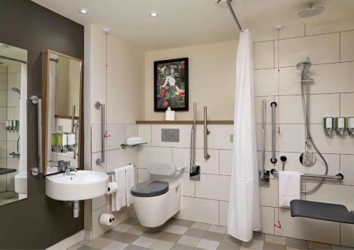 a bathroom with a toilet and a sink and a shower at Hampton By Hilton Dublin City Centre in Dublin