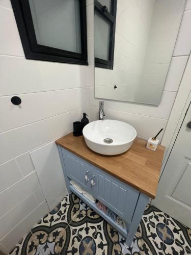a bathroom with a sink and a mirror at Lana's Guest House in Ḥurfeish