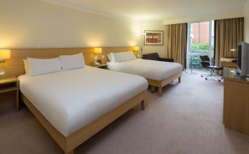 a hotel room with two beds and a television at Hilton Leicester Hotel in Leicester