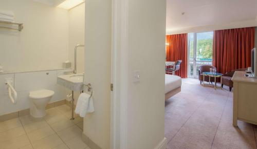 a bathroom with a sink and a toilet in a room at Hilton Leicester Hotel in Leicester