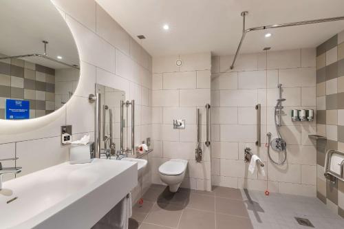 a bathroom with a sink and a toilet and a shower at Hampton By Hilton Torquay in Torquay