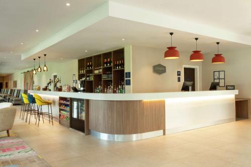a bar in the middle of a room at Hampton By Hilton Hamilton Park in Hamilton