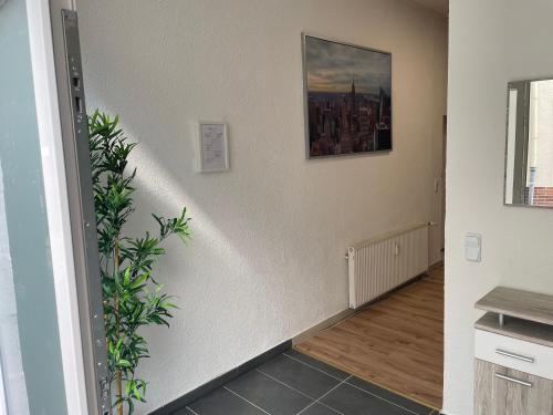 a hallway with a stairway with a painting on the wall at Schöne Wohnung mitten in Linz in Linz am Rhein