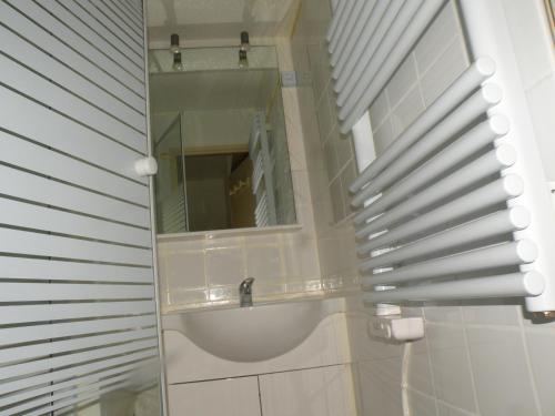 a bathroom with a sink and a mirror at Au Coeur De La Station in Les Deux Alpes