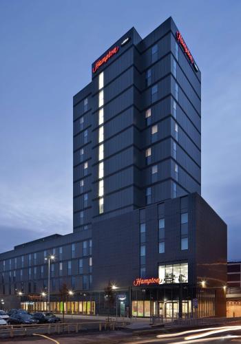 a tall black building with a sign on it at Hampton By Hilton Leeds City Centre in Leeds