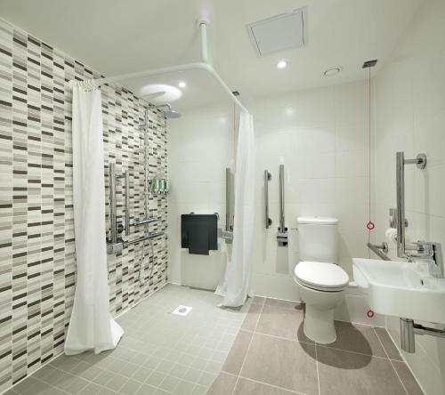 a white bathroom with a toilet and a sink at Hampton By Hilton Leeds City Centre in Leeds