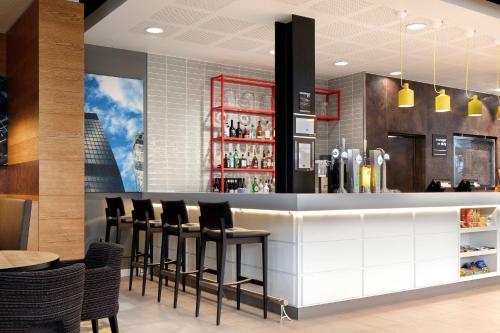 a bar in a restaurant with black stools at Hampton By Hilton London Docklands in London