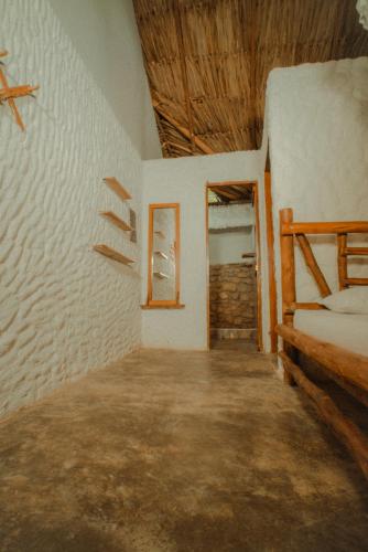 an empty room with a bed and a window at Praba Hostel in Palomino
