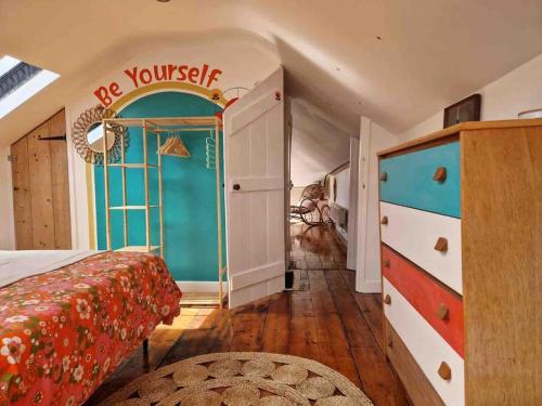 a bedroom with a bed and a door with a sign at Revival Retreat, with parking in Whitstable