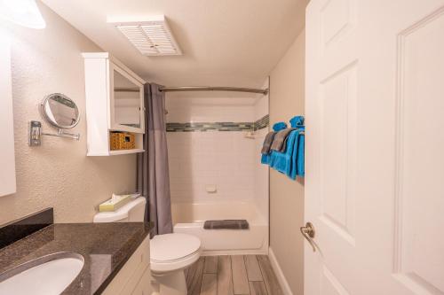a small bathroom with a toilet and a sink at Emerald on the Water - Formerly Belleair Beach Club in Clearwater Beach