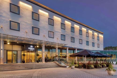 a hotel building with an umbrella in front of it at Hilton London Angel Islington in London