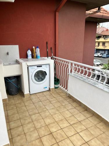 a washing machine on the balcony of a house at Relaxing apartments in Giardini Naxos