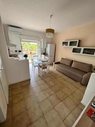 a living room with a couch and a table at Relaxing apartments in Giardini Naxos