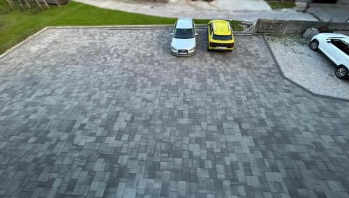 two cars parked on top of a driveway at Perfect Place for two in Kranj