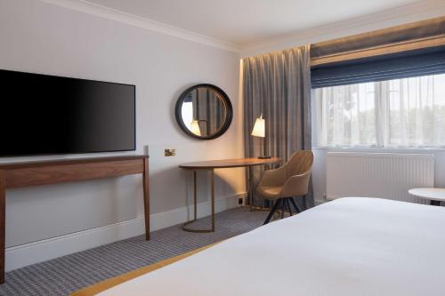 a hotel room with a bed and a flat screen tv at DoubleTree by Hilton Stoke-on-Trent, United Kingdom in Stoke on Trent