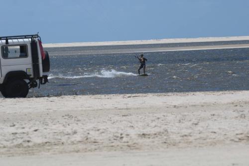 a person on a surfboard in the water at Rancho Dias in Atins