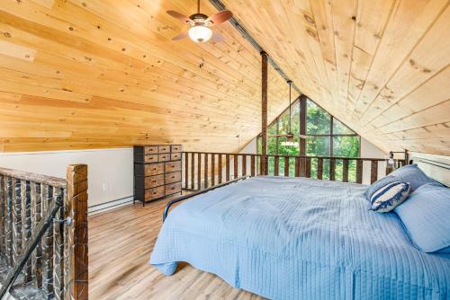 sypialnia z łóżkiem w drewnianym suficie w obiekcie Quaint Cabin w Hot Tub Firepit & Deck w mieście Hedgesville