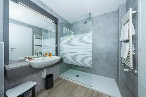 a bathroom with a sink and a shower at La Casa del Mulino in Merone