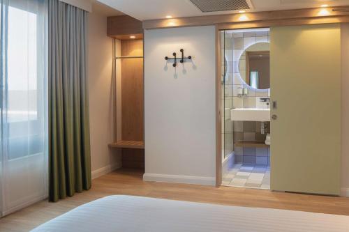 a bathroom with a shower and a sink at Hampton by Hilton York Piccadilly in York