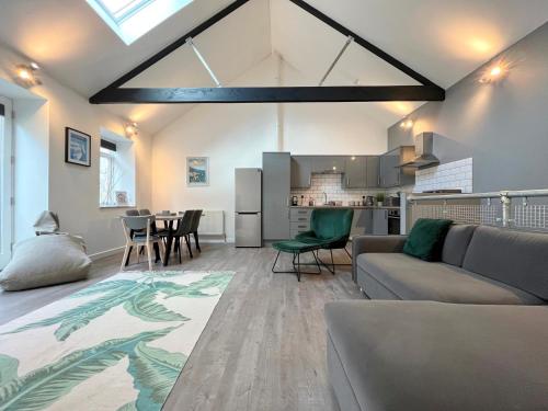 a living room with a couch and a table at Modern~ Reverse Level~2 bed~Townhouse~Central~Penzance in Penzance