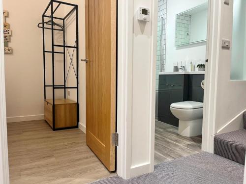 a bathroom with a toilet and a sink at Modern~ Reverse Level~2 bed~Townhouse~Central~Penzance in Penzance