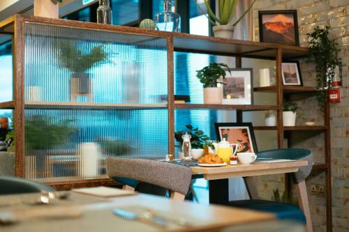 a dining room with a table and a large window at IXORA Hotel & Spa Snowdonia in Conwy