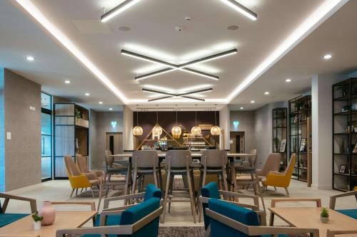 a dining room with a long table and chairs at Hilton Garden Inn Snowdonia in Conwy