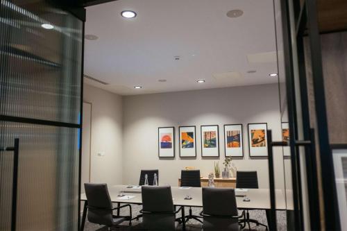 a meeting room with a table and chairs at IXORA Hotel & Spa Snowdonia in Conwy