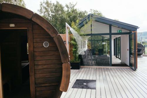 a building with a wooden door on a deck at IXORA Hotel & Spa Snowdonia in Conwy