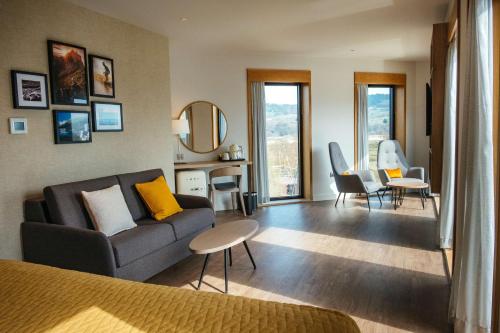 a living room with a couch and a table at IXORA Hotel & Spa Snowdonia in Conwy