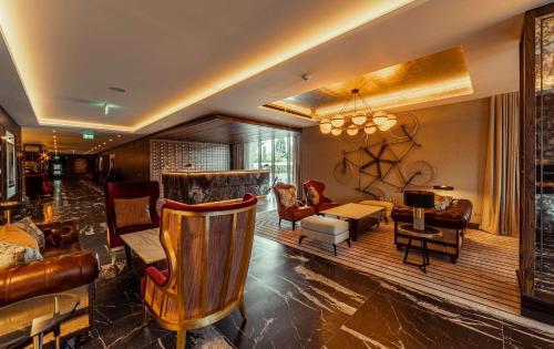 a living room with a couch and a table at The Fellows House Cambridge, Curio Collection By Hilton in Cambridge