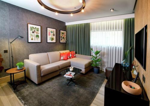 a living room with a couch and a tv at Hilton London Bankside in London