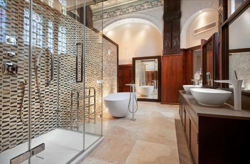 a large bathroom with two sinks and two toilets at DoubleTree by Hilton Hotel & Spa Liverpool in Liverpool