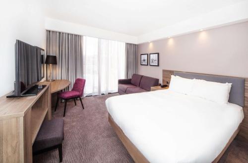 a hotel room with a large bed and a television at Hampton By Hilton Blackpool in Blackpool