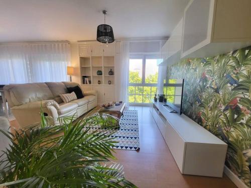 a living room with a couch and a large mural at Lisbon Family Residence in Lisbon