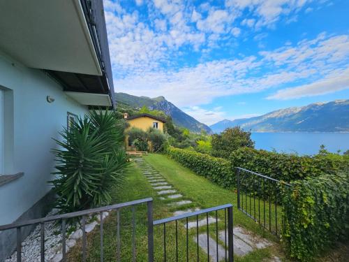 a balcony with a view of a lake and a house at CRISTOL 12 in Gargnano